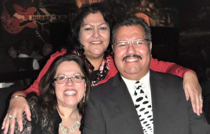 Kim Bullard, with her arms around her brother, James Bullard, and sister-in-law, Maria.