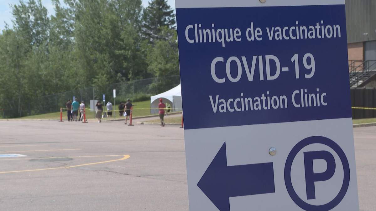 People lined up at the COVID-19 vaccination clinic at the Moncton Coliseum Tuesday