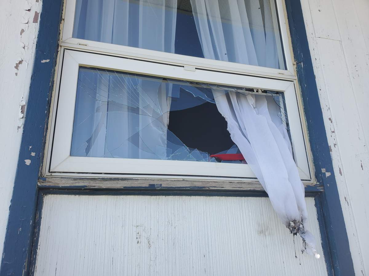 A broken window is seen at the Siksika Anglican Church after RCMP believe someone tried to start a fire in the church.