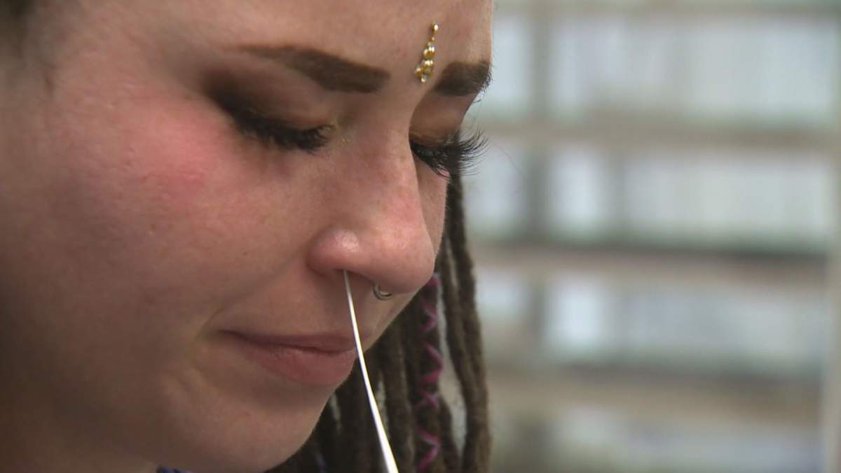 A woman takes a rapid test for COVID-19