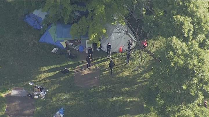 Police and city crews clearing out encampment residents at Trinity Bellwoods Park in Toronto on June 22, 2021.