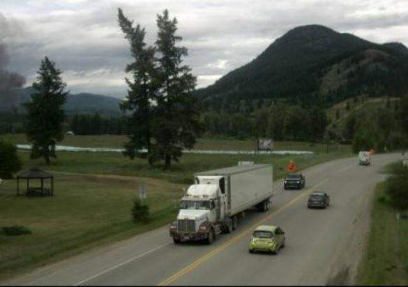 This Drive BC camera is situated at Hwy 5, in Little Fort at Hwy 5/Hwy 24 junction, looking north. It appears black smoke can be seen on the left of the image.

