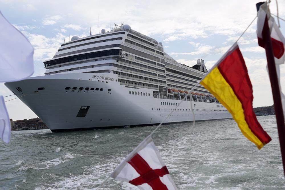 The the 92,409-ton, 16-deck MSC Orchestra cruise ship exits the lagoon as it leaves Venice, Italy, Saturday, June 5, 2021. (AP Photo/Antonio Calanni)