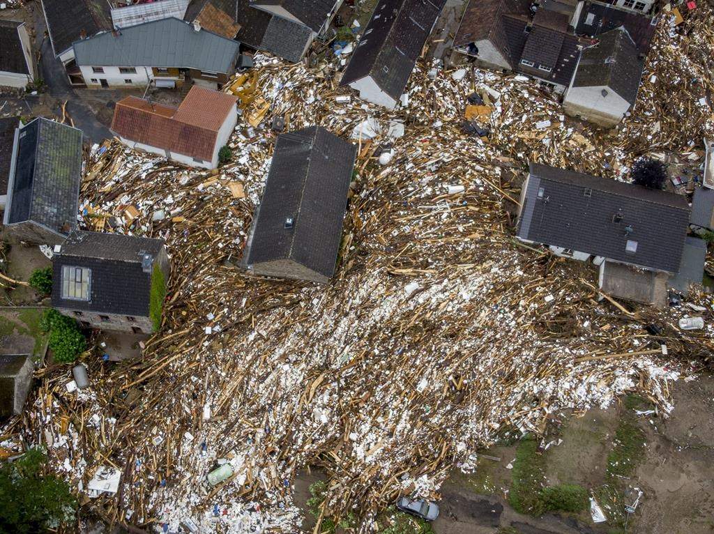 Debris of houses and trees surround houses in Schuld, Germany, Friday, July 16, 2021.
