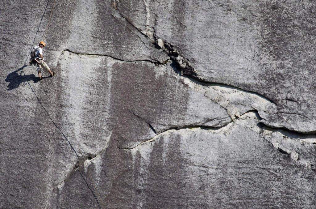 A climber is dwarfed by the massive rock face of the Chief in Stawamus Chief Provincial Park in Squamish, B.C., on August 16, 2009. THE CANADIAN PRESS/Jonathan Hayward.