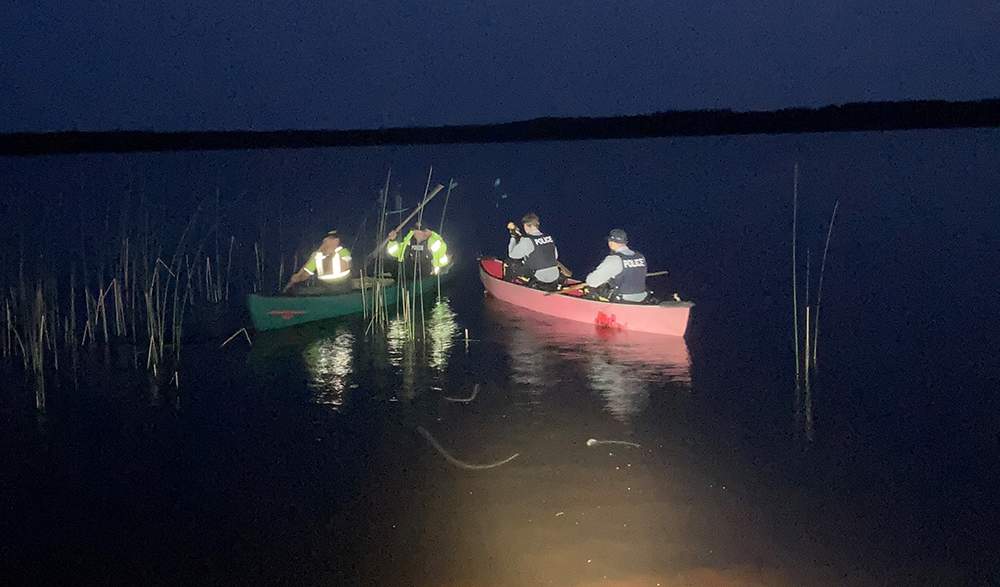 Mounties say they paddled approximately one kilometer across a lake to rescue a pair of stranded boaters, who were found in good health.