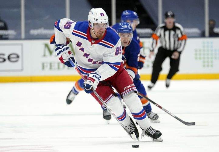 FILE – In this April 11, 2021, file photo, New York Rangers’ Pavel Buchnevich (89) skates with the puck during the third period of an NHL hockey game against the New York Islanders in Uniondale, N.Y. The Rangers continued their offseason makeover Friday, July 23, 2021, by trading fourth-leading scorer Buchnevich to the St. Louis Blues for forward Sammy Blais and a 2022 second-round pick.