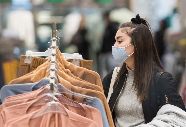 A woman wears a face mask as she shops in a store in Montreal, Sunday, November 22, 2020, as the COVID-19 pandemic continues in Canada and around the world.
