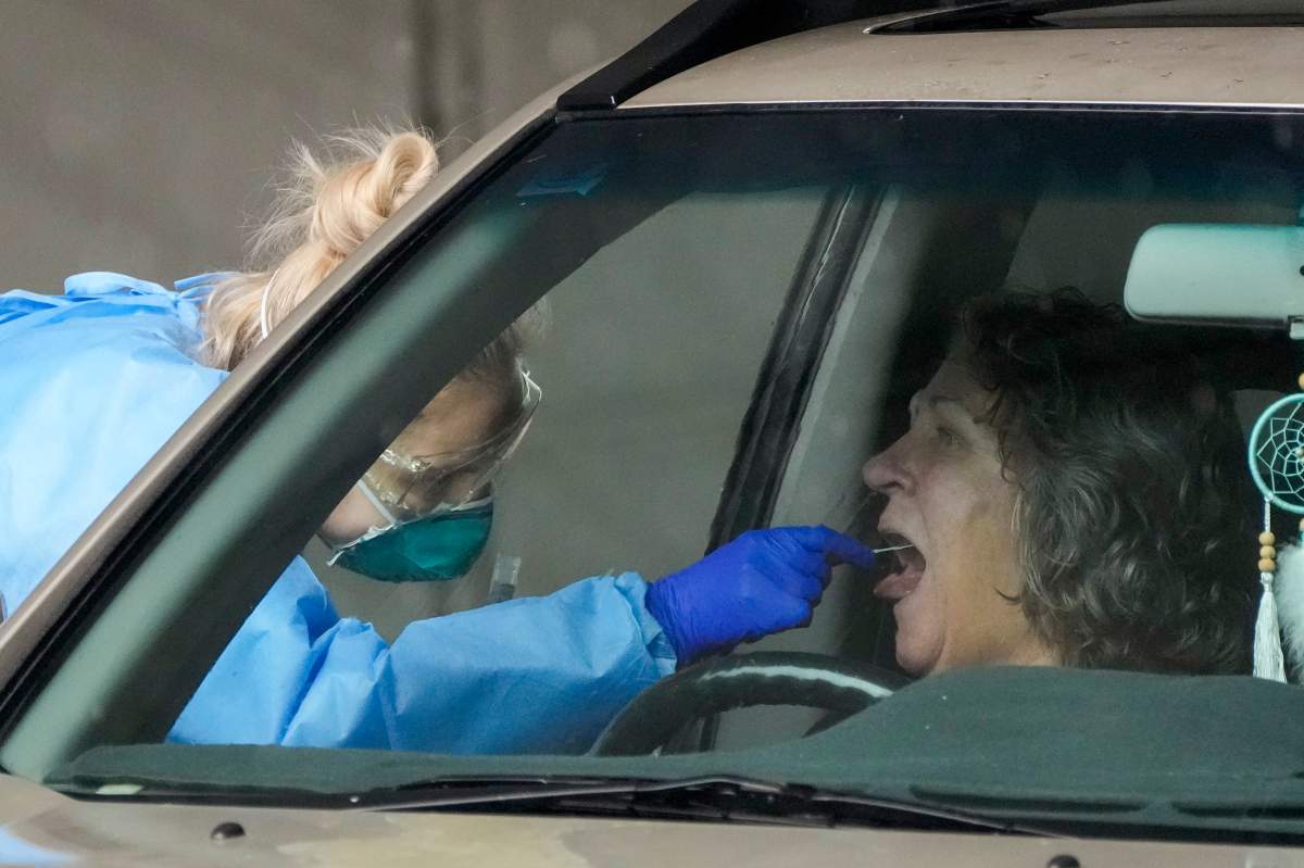 A woman receives a COVID-19 test at a testing station in Nelson Bay, Australia, Monday, June 28, 2021.