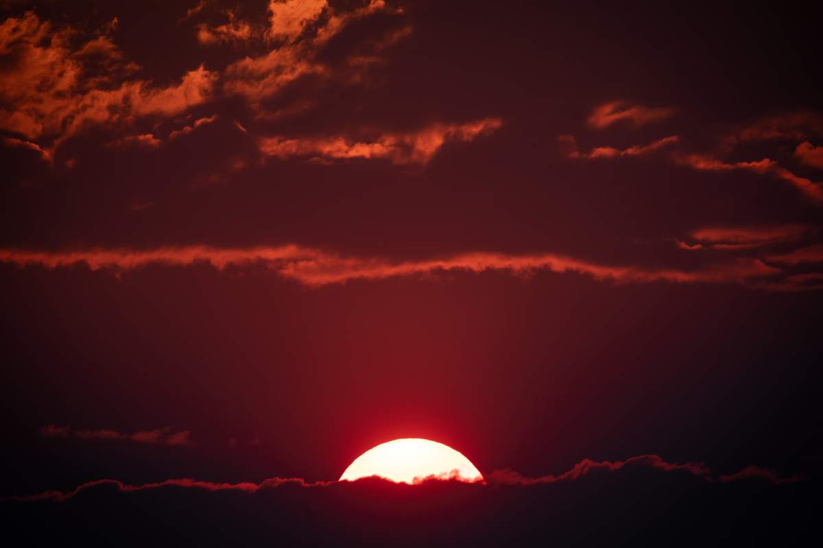 Smoke particles from wildfires burning in the area enhances the colour of the sunset near Logan Lake, B.C., on Thursday, July 15, 2021.