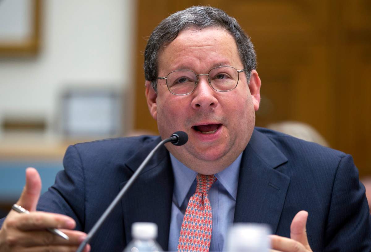 In this May 8, 2014 file photo David Cohen, Executive Vice President, Comcast Corporation testifies during the House Judiciary Subcommittee on Regulatory Reform, Commercial, and Antitrust Law oversight hearing on the proposed merger of Comcast and Time Warner Cable, on Capitol Hill in Washington.