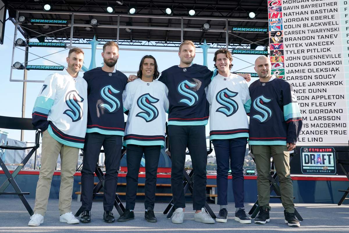 Seattle Kraken NHL hockey players Jordan Eberle, Chris Dreidger, Brandon Tanev, Jamie Oleksiak, Hadyn Fluery and Mark Giordano, from left, pose for a photo Wednesday, July 21, 2021, after being introduced during the Kraken’s expansion draft event in Seattle.