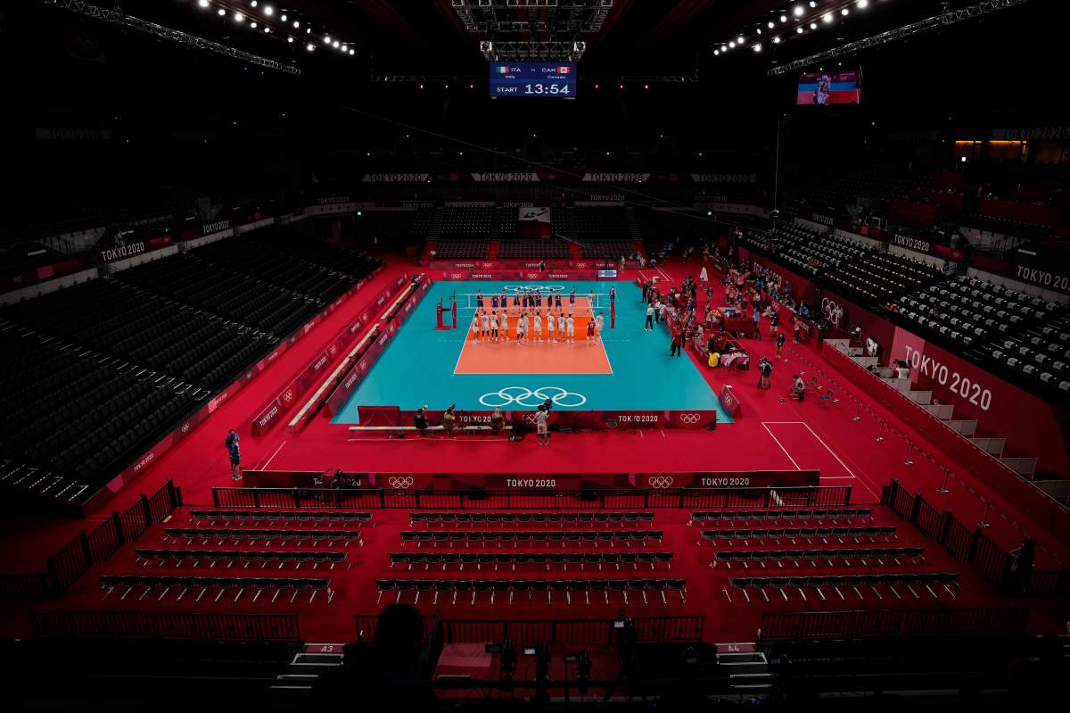 Both teams line up before the men’s volleyball preliminary round pool A match between Italy and Canada at the 2020 Summer Olympics, July 24, 2021, in Tokyo, Japan.