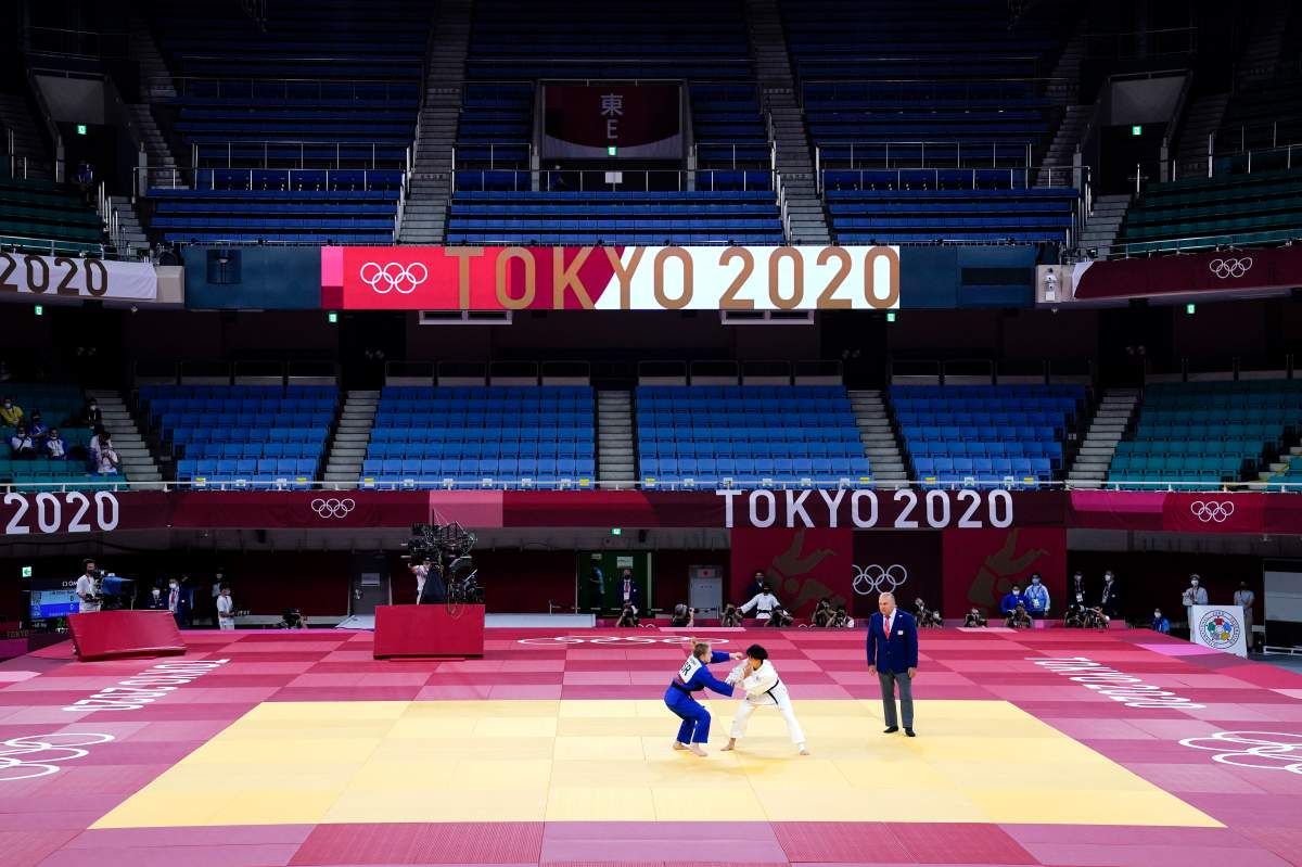 Lin Chen-hao, center right, of Taiwan, and Shira Rishony, of Israel, compete in a women’s 48-kg match with no spectators attending at the 2020 Summer Olympics, July 24, 2021, in Tokyo.