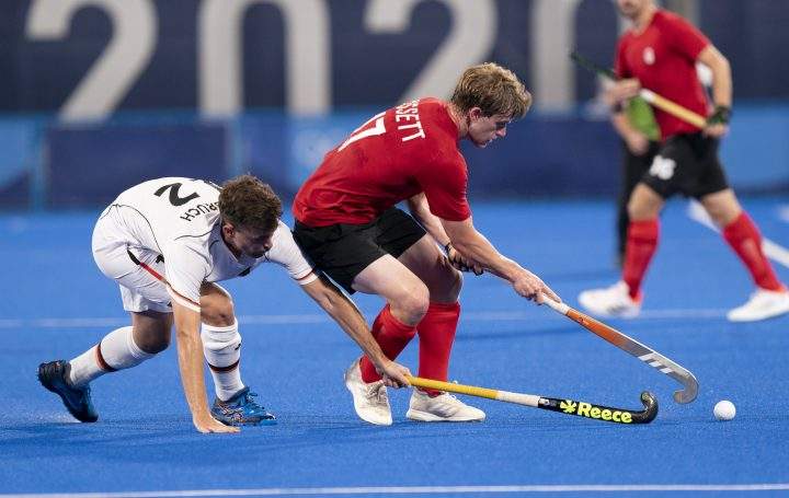 Canada’s Brenden Bissett controls the ball under pressure from Germany’s Tim Herzbruch during first half field hockey action at the Tokyo Olympics, Saturday, July 24, 2021 in Tokyo, Japan. THE CANADIAN PRESS/Adrian Wyld