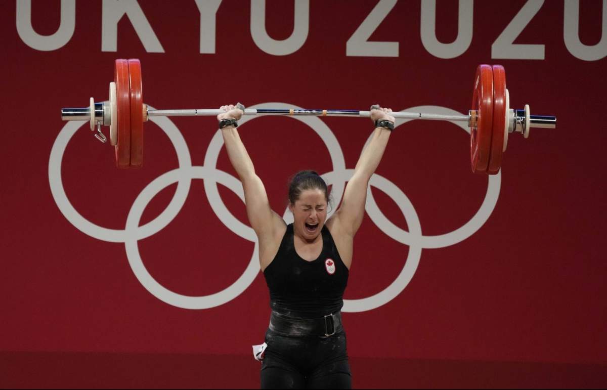Maude G. Charron of Canada celebrates after a lift in the women’s 64kg weightlifting event, at the 2020 Summer Olympics, Tuesday, July 27, 2021, in Tokyo, Japan. (AP Photo/Luca Bruno)