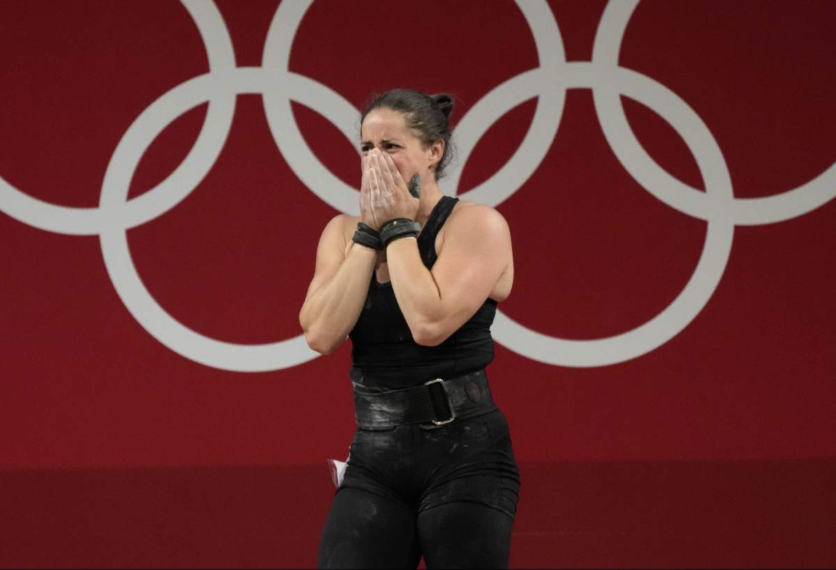 Maude G. Charron of Canada cries after the last lift in the women’s 64kg weightlifting event, at the 2020 Summer Olympics, Tuesday, July 27, 2021, in Tokyo, Japan. (AP Photo/Luca Bruno)
