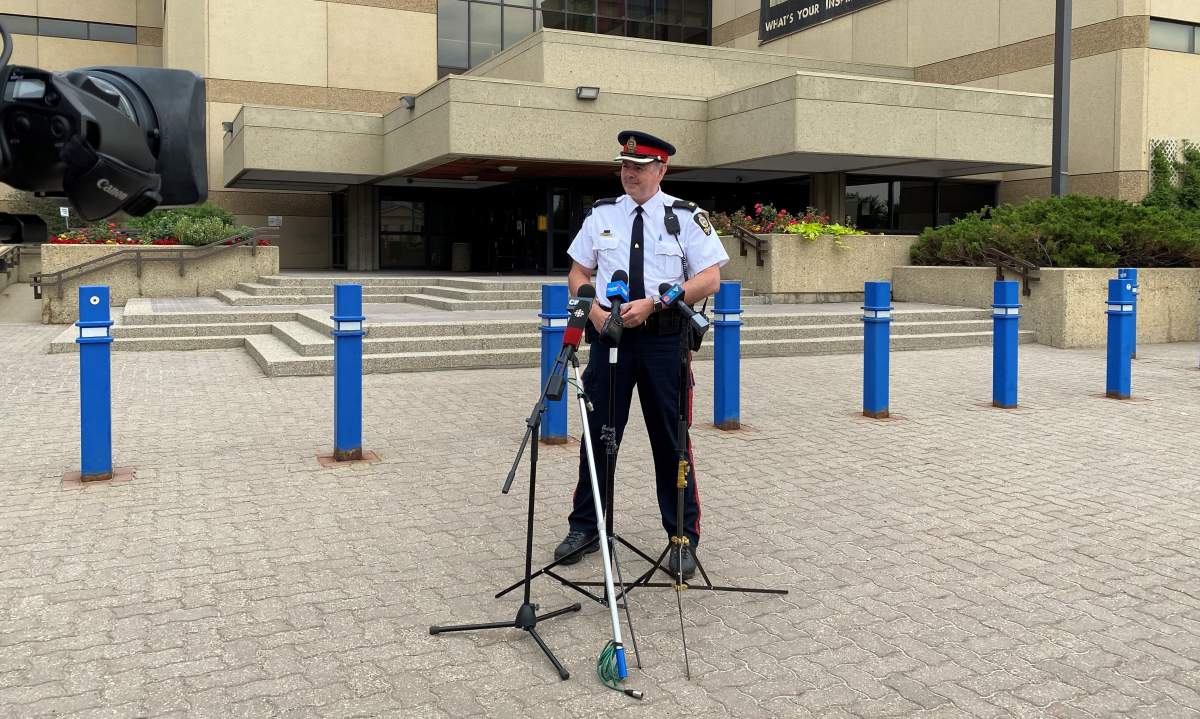 Edmonton Police Service Insp. Erik Johnson speaks with journalists outside the downtown headquarters on Friday, July 16, 2021.