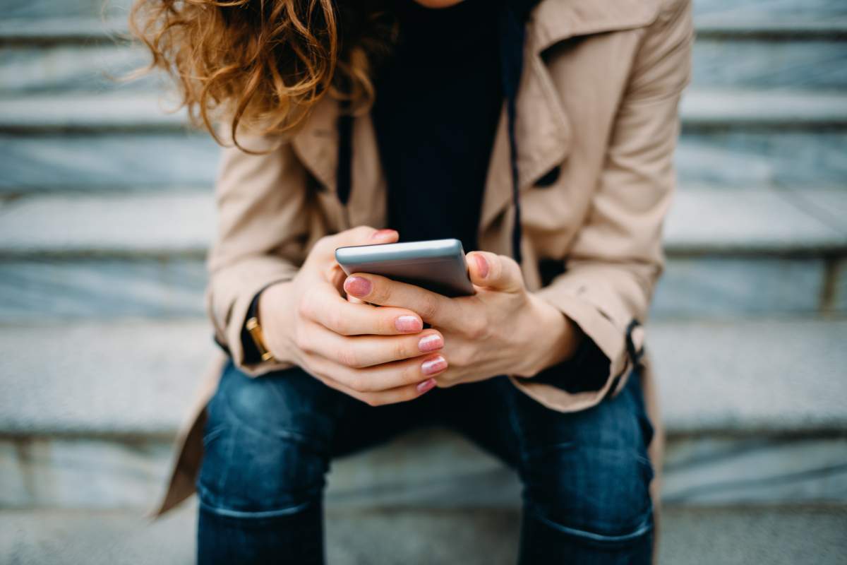 File photo of a woman holding a cell phone.