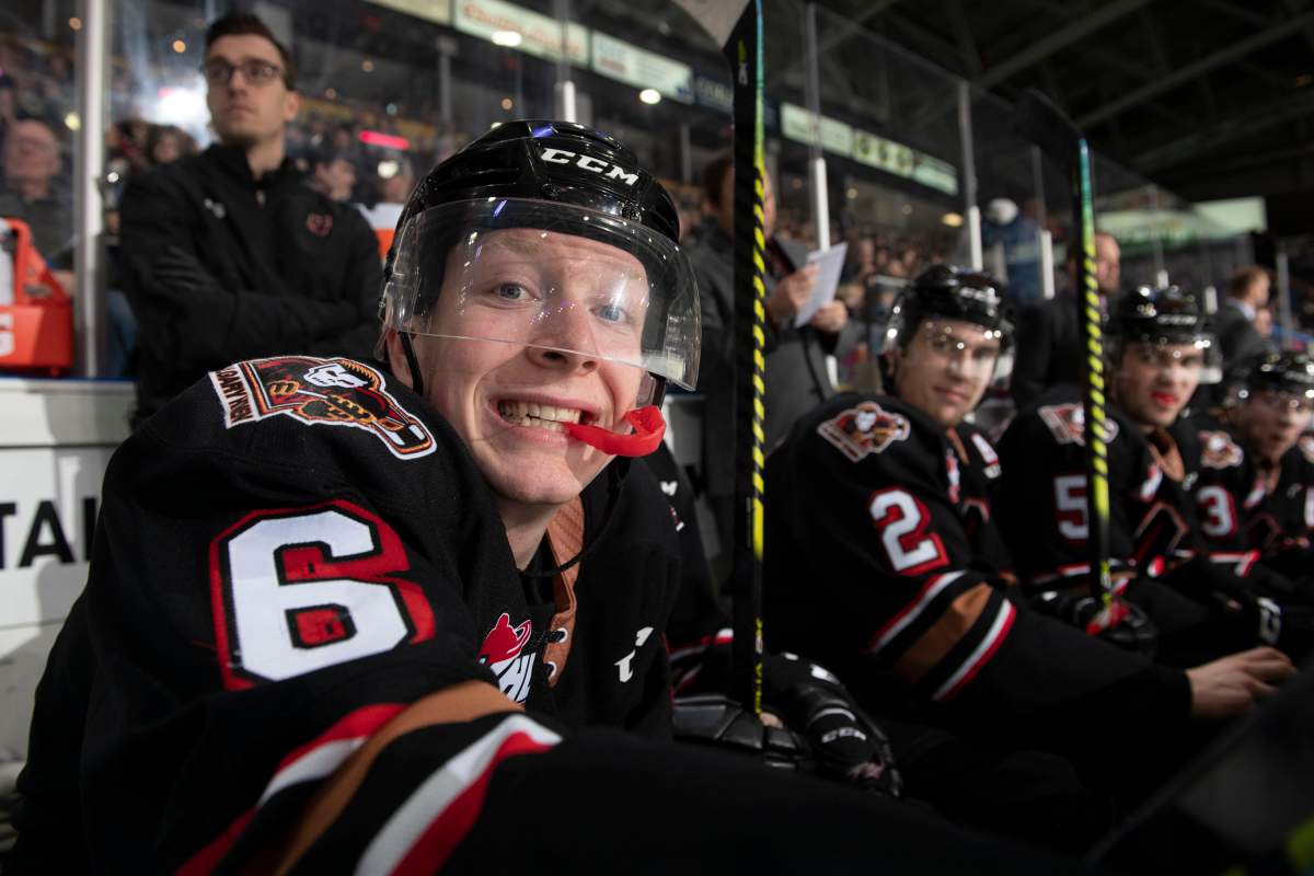 Luke Prokop #6 of the Calgary Hitmen sits on the bench and hams it up for the camera during third period against the Kelowna Rockets at Prospera Place on February 17, 2020 in Kelowna.