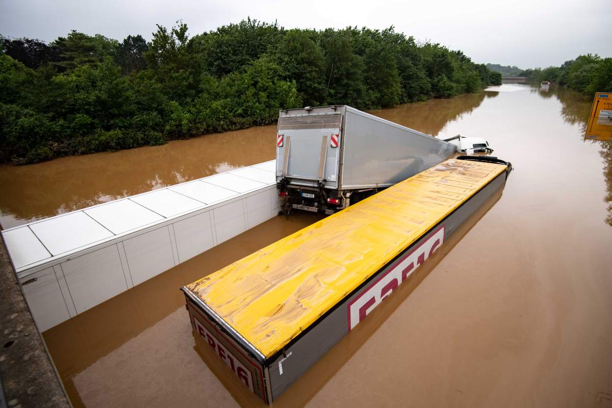 North Rhine-Westphalia, Erftstadt, Germany: Trucks are wedged into each other on a flooded highway.