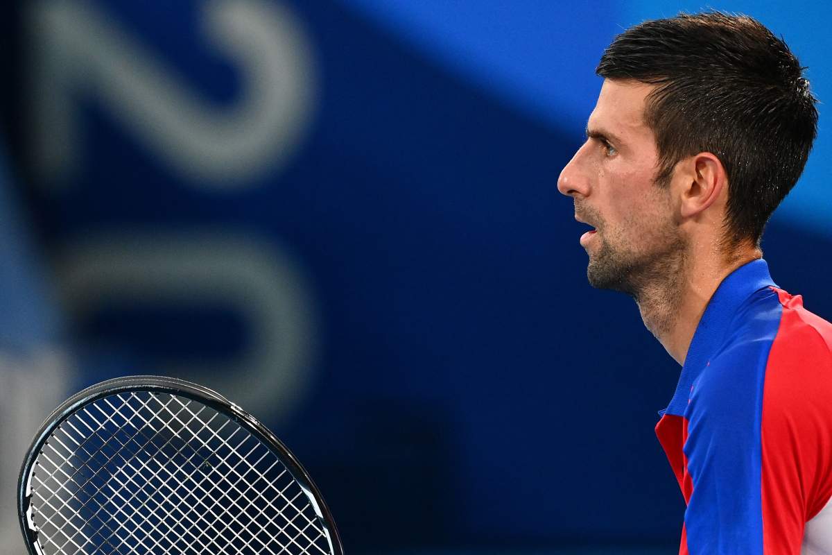 Serbia's Novak Djokovic prepares to returns the ball to Germany's Alexander Zverev during their Tokyo 2020 Olympic Games men's singles semifinal tennis match at the Ariake Tennis Park in Tokyo on July 30, 2021. 