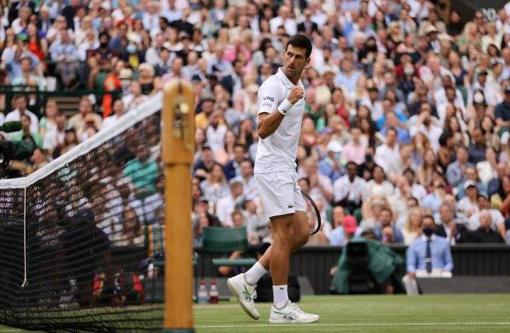Novak Djokovic of Serbia celebrates in his men’s singles semi-final match against Denis Shapovalov of Canada at All England Lawn Tennis and Croquet Club on July 09, 2021 in London, England.