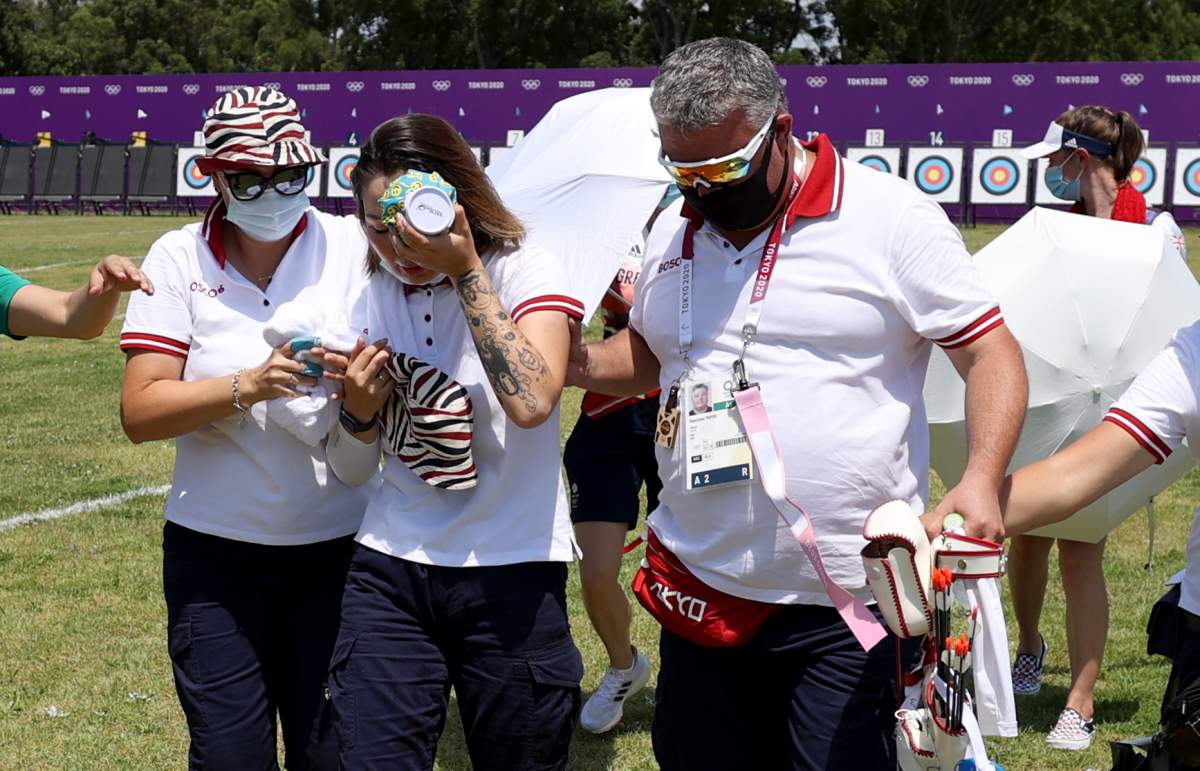 Svetlana Gomboeva of Team ROC is treated for heat exhaustion in the Women’s Individual Ranking Round during the Tokyo 2020 Olympic Games at Yumenoshima Park Archery Field on July 23, 2021, in Tokyo, Japan.
