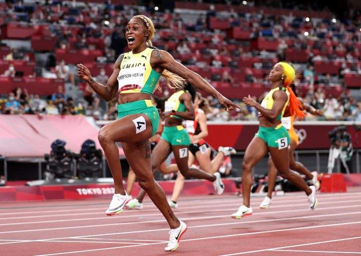 TOKYO, JAPAN - JULY 31: Elaine Thompson-Herah of Team Jamaica celebrates as she crosses the finish line to win the gold medal in the Women's 100m Final on day eight of the Tokyo 2020 Olympic Games at Olympic Stadium on July 31, 2021 in Tokyo, Japan. 
