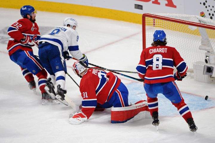 Tampa Bay Lightning’s Tyler Johnson (9) scores on Montreal Canadiens’ goaltender Carey Price (31) as Canadiens’ Erik Gustafsson (32) and Canadiens’ Ben Chiarot (8) defend during the third period in Game 3 of the Stanley Cup finals in Montreal on Friday, July 2, 2021.