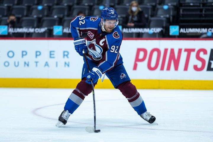 Colorado Avalanche left wing Gabriel Landeskog (92) hits the puck for a goal against the Los Angeles Kings during the second period of an NHL hockey game Wednesday, May, 12, 2021, in Denver.