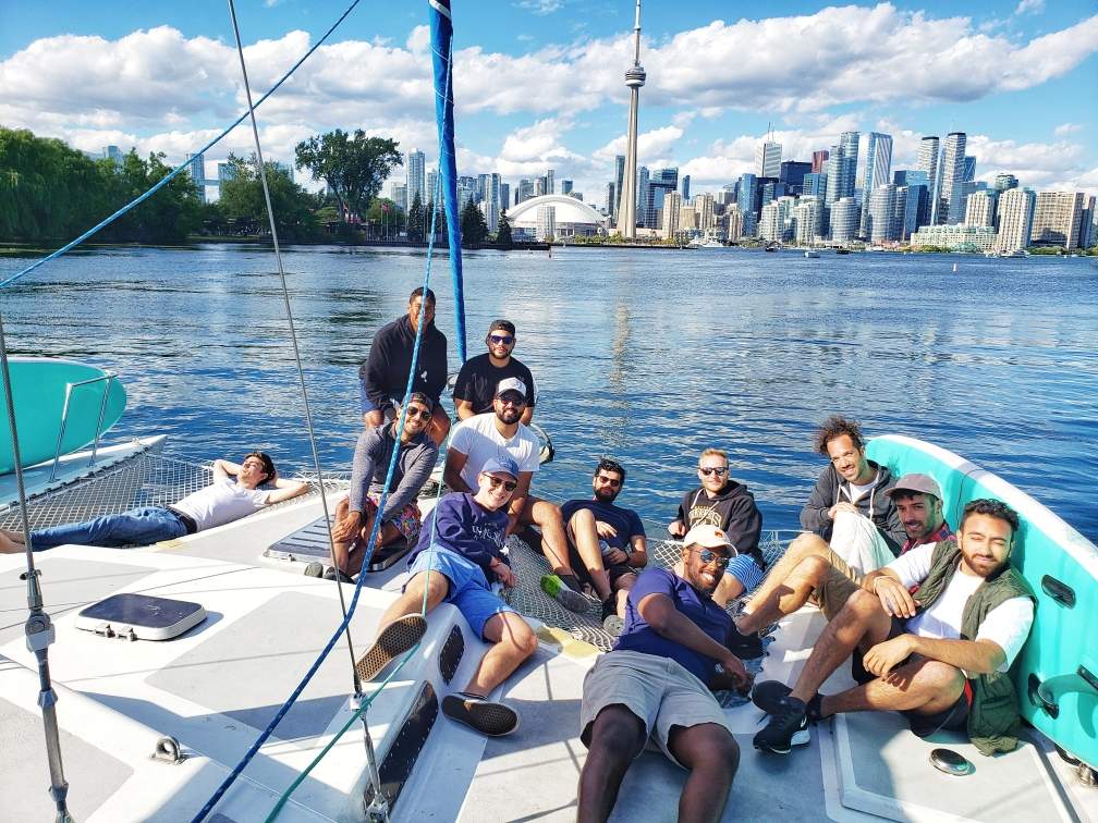 Lazer Technologies employees pose with Toronto's CN Tower in the background