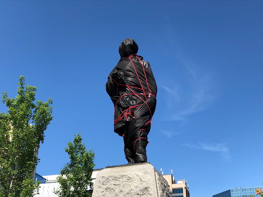 The statue of Canada’s first prime minister in Gore Park in downtown Hamilton was covered up with black cloth and red rope ahead of National Indigenous Peoples Day.