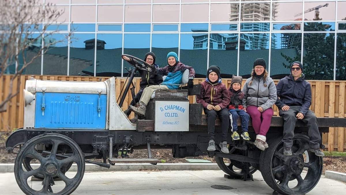 Vicky Ringuette and Alexandre Lessard with their four sons shown on an antique vehicle during a stop on their travels. The family of six has been travelling for the past eight months across Canada.