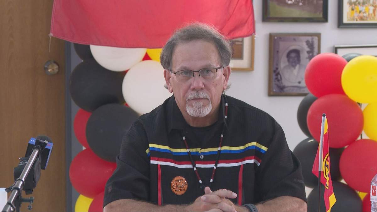 Natoaganeg First Nation Chief George Ginnish sits at a desk