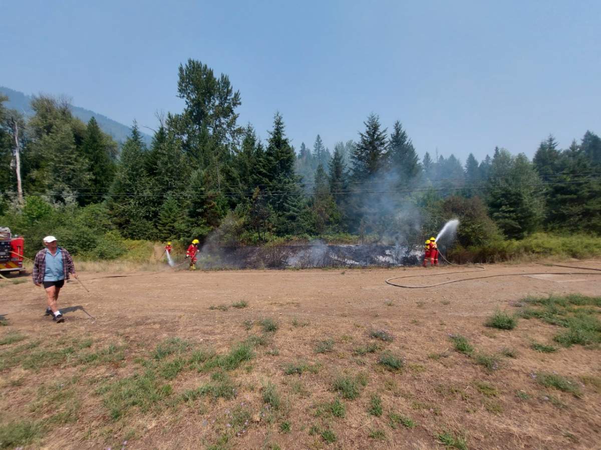 Firefighters on the scene of suspicious fire in Salmo on Saturday, July 24.