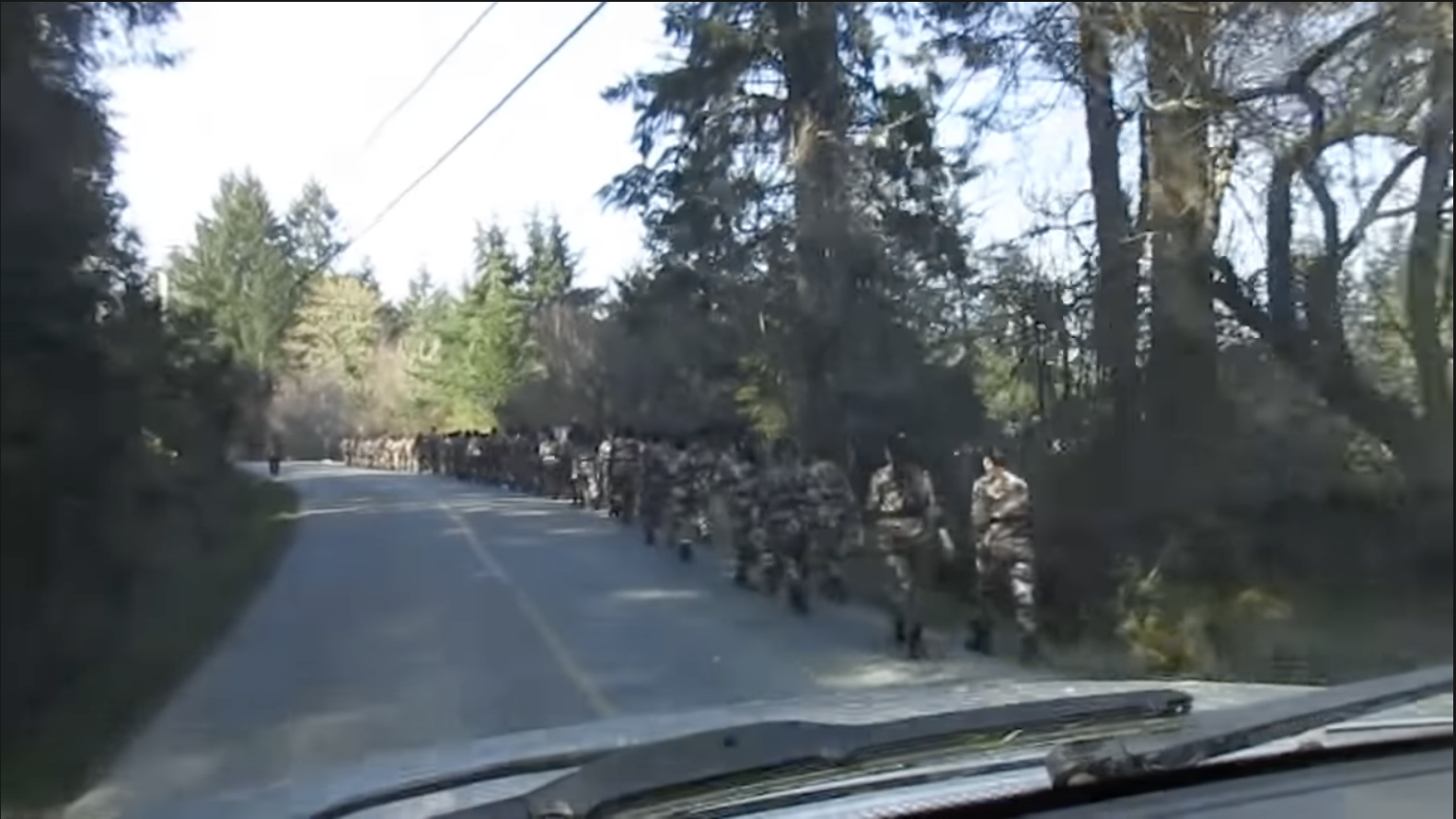A screenshot from a video recorded by Salt Spring Island resident Joe Clemente in March 2018, which appears to show around 50 East Asian-looking men and women marching in military uniforms.