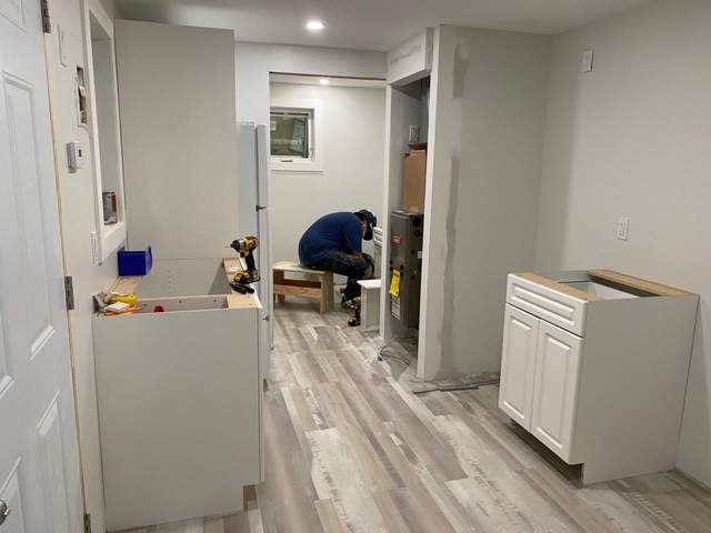 Trey Wells-Creighton installs cabinets in a tiny home built on the Blood Reserve. July 22, 2021.