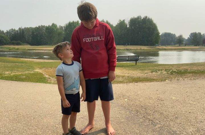 Five-year-old Bo (left) was rescued from a pond in Whitecourt, Alta., by 11-year-old Austin Loiseau (right).