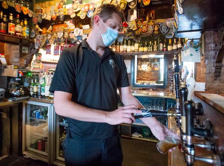 Bartender Neil Creighton pulls a pint of beer at Hurley's Pub Wednesday, September 30, 2020  in Montreal. 