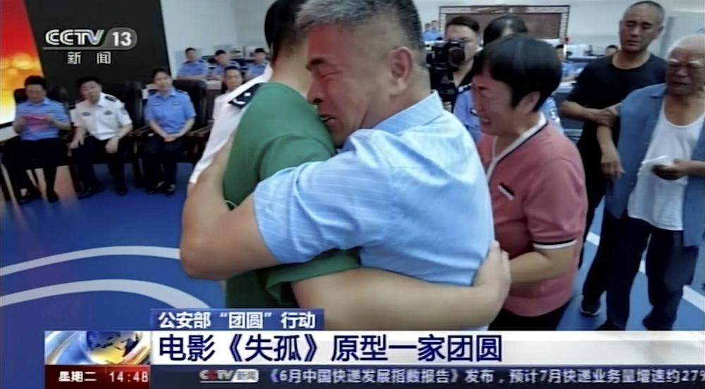 In this image taken from a video footage run by China's CCTV via AP Video, Guo Gangtang at right embraces his long lost son Guo Xinzhen during a reunion after 24 years in Liaocheng in Central China's Shandong province on Sunday, July 11, 2021. Guo was abducted as a toddler outside their home.