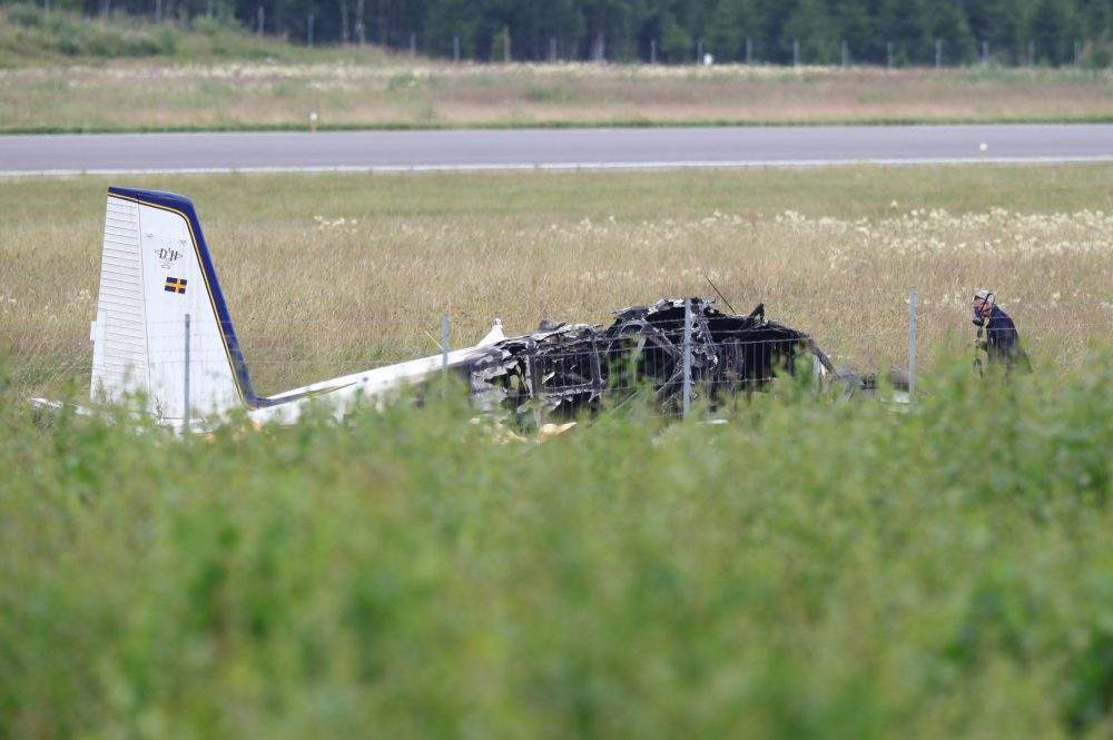 Police investigate the site of a plane crash near Orebro, Sweden, on July 9, 2021.