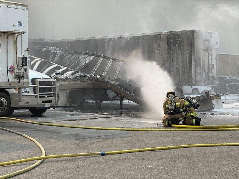 Calgary firefighters battle a blaze at a trailer parked at the loading dock of Stericycle in Southeast Calgary on Wednesday, July 28, 2021.