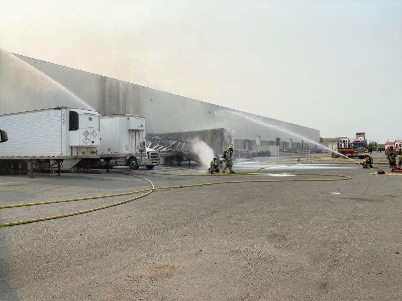 Calgary firefighters battle a blaze at a trailer parked at the loading dock of Stericycle in Southeast Calgary on Wednesday, July 28, 2021.