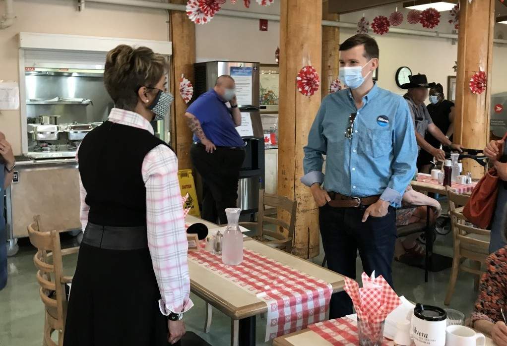 Calgary councillors Jyoti Gondek, L, and Jeromy Farkas meet at a Stampede-themed breakfast at a Silvera for Seniors location, pictured on July 14, 2021.