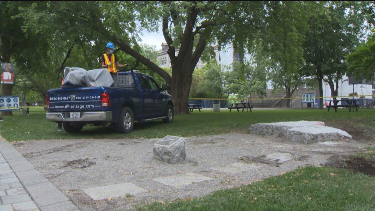 Workers remove the statue of university of founder James McGill. Friday, July 9, 2021.