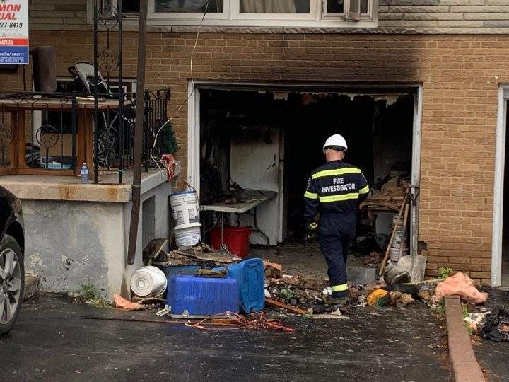 A fire investigator at the scene of a house fire in Mississauga on Saturday.