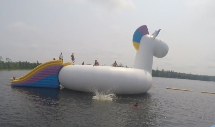 The water park features a 50-foot inflatable unicorn that attendees can climb to the top of and jump from. (Graeme Benjamin/Global News)