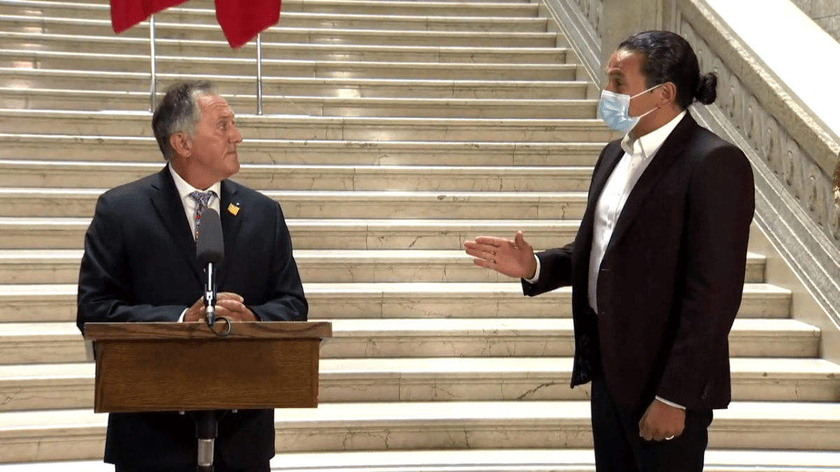 NDP leader Wab Kinew, right, speaks to Dr. Alan Lagimodiere, the province's new Indigenous and recondiliation and northern affairs minister, at a press conference on July 15, 2021. On Friday Lagimodiere apologized for his comments on residential schools.