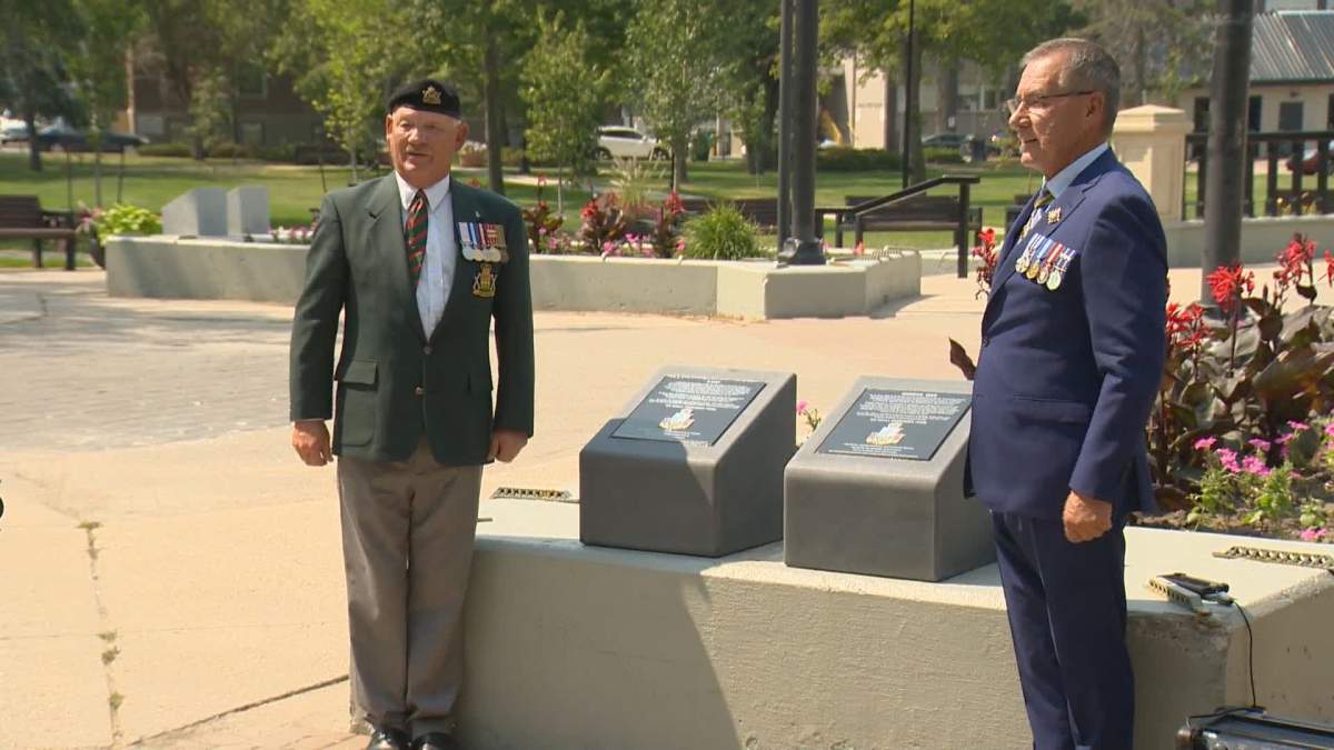 Brad Hrycyna, president of the Royal United Services Institute of Regina, and Lieutenant-Governor Russ Mirasty stand next to the freshly revealed pedestals in Victoria Park on Tuesday, July 27, 2021.